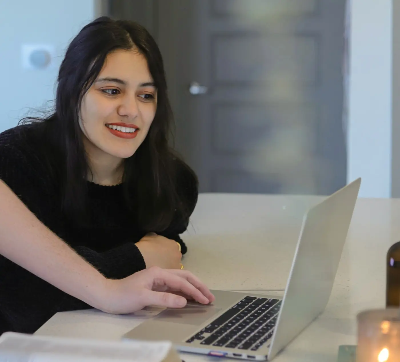 A high-school student works through her college plan on a laptop with a helping hand